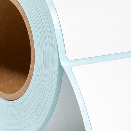 Permanent adhesive backing on direct thermal label roll